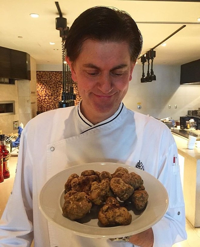 Cef Fabrizio Schenardi holding a plate of Alba white truffles