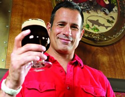 Sam Calagione, founder and president of Dogfish Head Craft Brewery, raises a glass