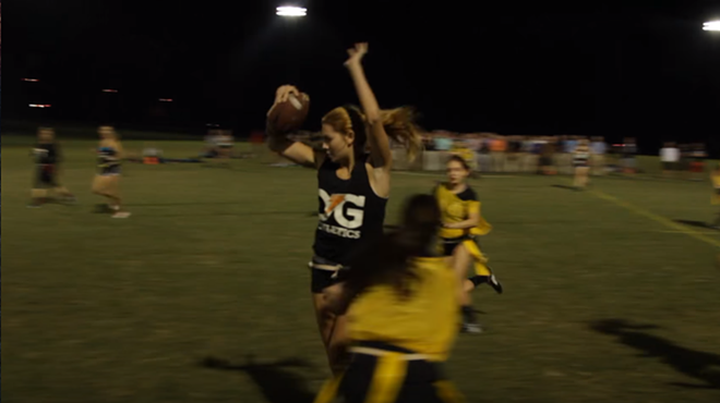 Roque jukes past a defender during an intramural flag football game. - PHOTO VIA YOUTUBE