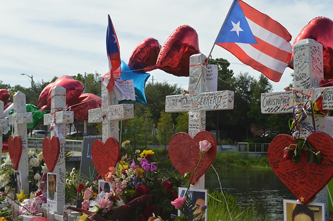 Puerto Rican flags fly over the cross memorial installed near Orlando Regional Medical Center. - Photo by Monivette Cordeiro