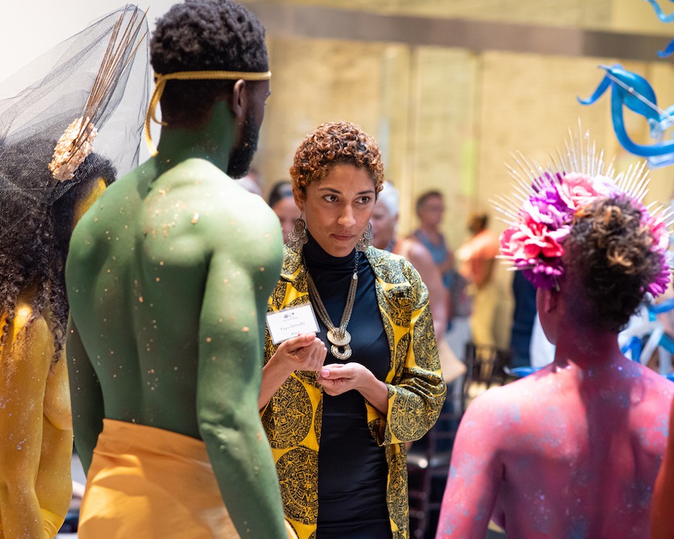 Artist and poet YaYa Delvalle, who exhibited her work at the 1st Thursdays event, shares an exchange with the Rainbow Myriads. - Photo by Matt Keller Lehman