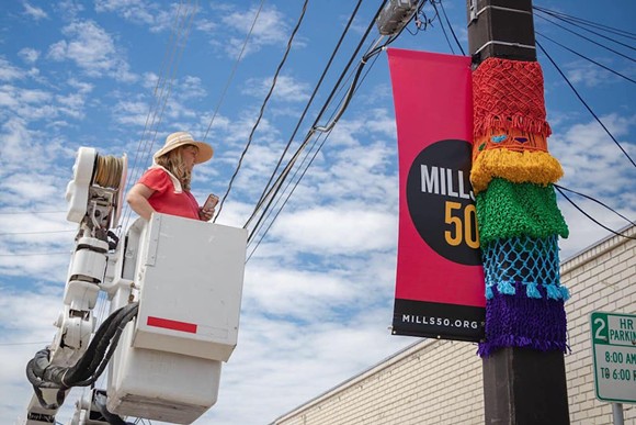 Victoria Walsh, also known as "Macrame Momma," installing a work in Mills 50 - IMAGE VIA VICTORIA WALSH / FACEBOOK