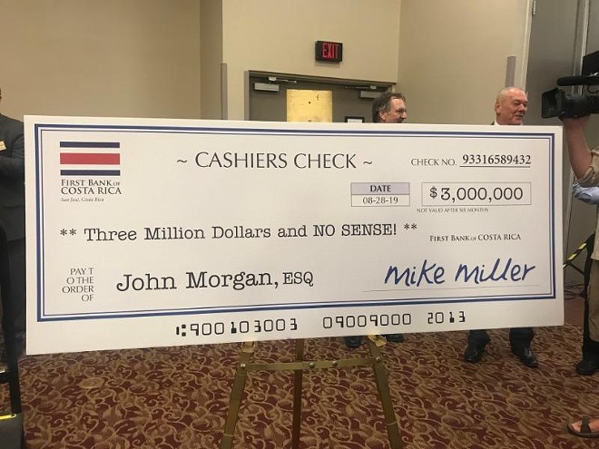The Tiger Bay Club in Tallahassee displayed for Morgan a giant, fake check to poke fun at an ethics probe that included allegations about Gillum traveling to Costa Rica with an undercover FBI agent, who posed as Mike Miller. - Photo courtesy News Service of Florida