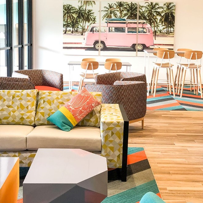The lobby of Beachside Hotel and Suites embraces Cocoa Beach's rich surf history - IMAGE VIA BEACHSIDE HOTEL & SUITES