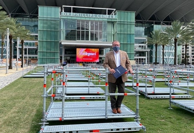 Mayor Dyer tries out a Frontyard Festival seating pod - Photo courtesy Orlando Mayor Buddy Dyer/Facebook