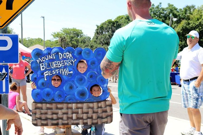 Festival goers at the 2018 Mount Dora Blueberry Festival take pictures in the blueberry sign. - Photo via Mount Dora Blueberry Festival/Facebook