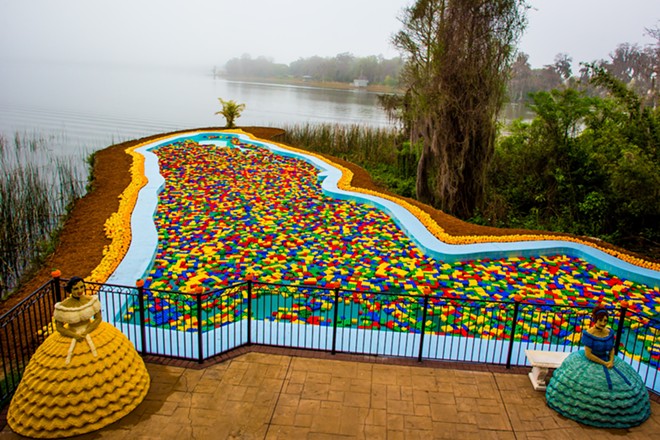 The famed Florida Pool filled with LEGOs in a promotional photo shared when the pool was first restored and reopened. Two of the Southern Belle LEGO sculptures flank the pool. - Image via Legoland Florida
