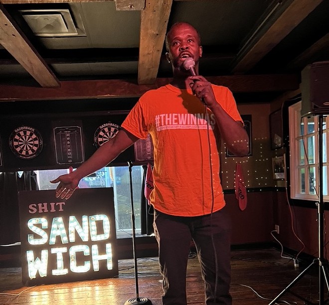 Orlando comedian David Jolly delivers a set beside the cherished Shit Sandwich sandwich board - Photo by Sarah Kinbar