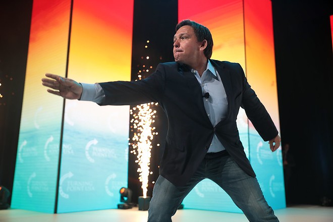 Florida governor Ron DeSantis does a little magic trick and makes his state's place in the modern world, as well as his own lips, disappear