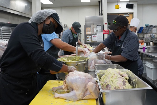The Catering for Good team seasoning a turkey. - photo courtesy Second Harvest