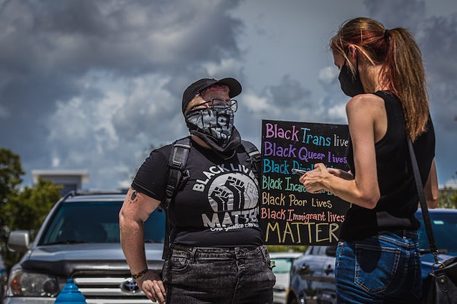 A BLM protester speaks to reporter McKenna Schueler outside a press conference with then-Vice President Mike Pence and Florida Gov. Ron DeSantis in Tampa, Florida. - photo by Dave Decker