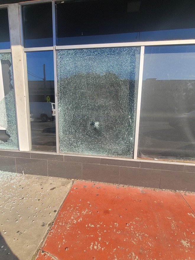 Bullet hole in the window of Milk District LGBTQ bar District Dive - Photo by Blue Star