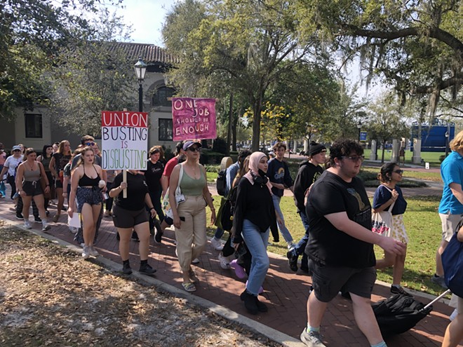 Students and faculty at Rollins College march in support of dining workers' union rights. - McKenna Schueler