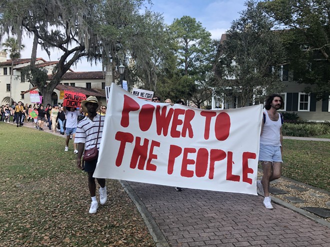 Students and faculty at Rollins College march in support of dining workers' rights to organize for a union. - McKenna Schueler/Orlando Weekly