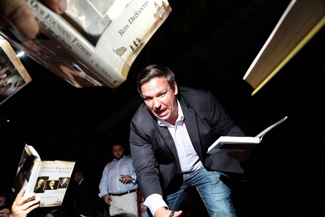Ron DeSantis signs copies of his book "Dreams From Our Founding Fathers" at UCF - Photo by Joey Roulette