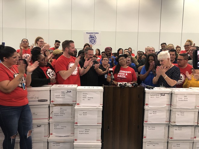 Tiana Moton (middle) surrounded by Disney World workers in union shirts in Central Florida on March 29, 2023. - McKenna Schueler/Orlando Weekly