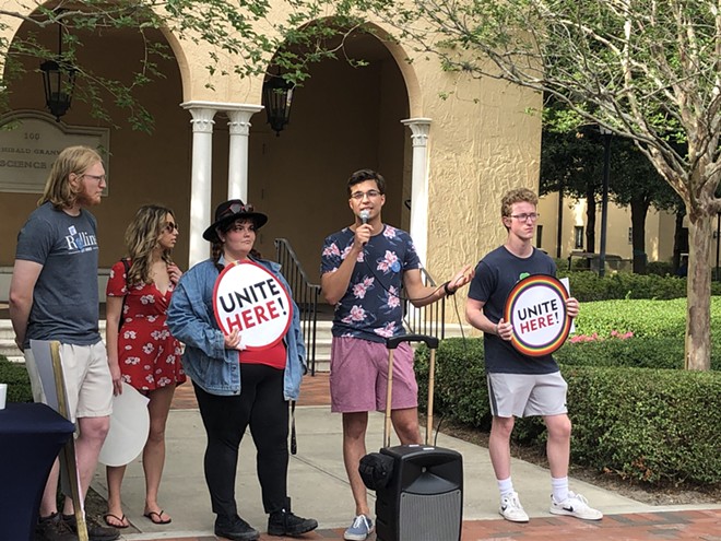 Mikhail Guchkov, a Rollins College student, speaks to other students and faculty gathered for a rally in support of dining workers' rights on April 19, 2023. - McKenna Schueler