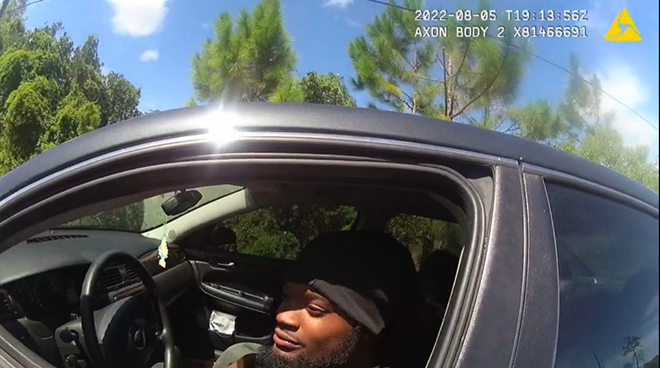 In a screenshot from a sheriff's body camera video, Darius Jermaine Ned Thomas Jr., 22, of Jacksonville, Florida, leans out his driver's window Aug. 5, 2022, to accept a $114 ticket from Jacksonville Sheriff's Office deputy M.L. Albert for playing his music too loudly. Black drivers, like Thomas, are more than three times as likely as whites to be pulled over and ticketed under the law, according to a new investigation by the University of Florida College of Journalism and Communications. - Photo courtesy of Jacksonville Sheriff's Office