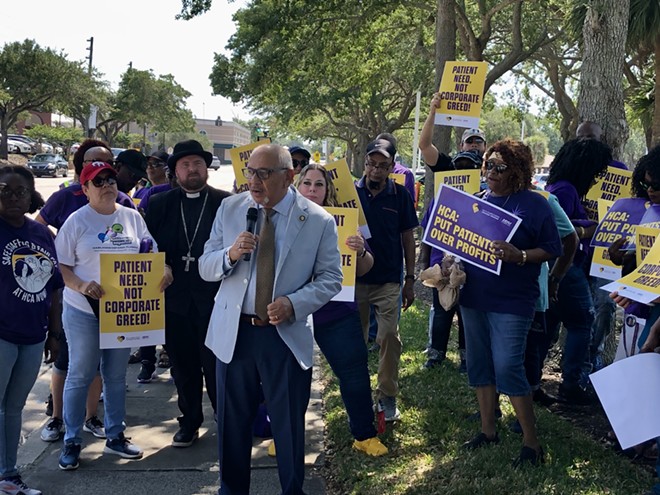 State Sen. Victor Torres, D-Orlando, stands with hospital workers outside HCA Florida Osceola Hospital. - photo by McKenna Schueler