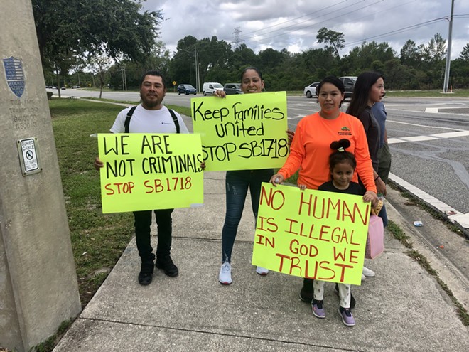 A family attends an Orlando demonstration against an immigration policy described as one of the harshest in the country, targeting undocumented people. - McKenna Schueler