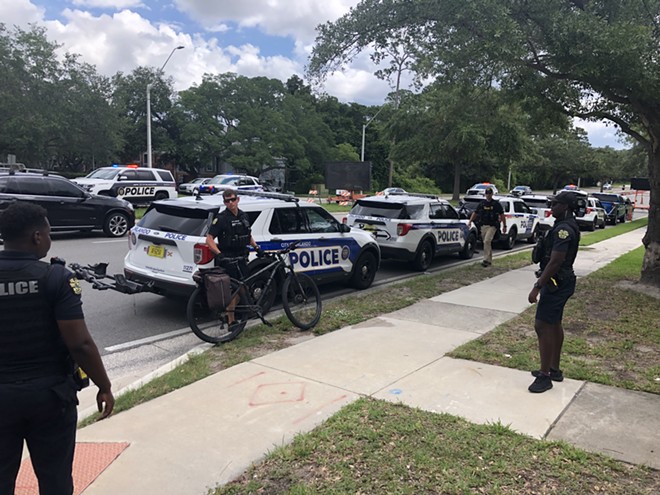 Orlando police cruisers line Conway road in response to traffic complaints tied to an immigrant rights demonstration. - McKenna Schueler