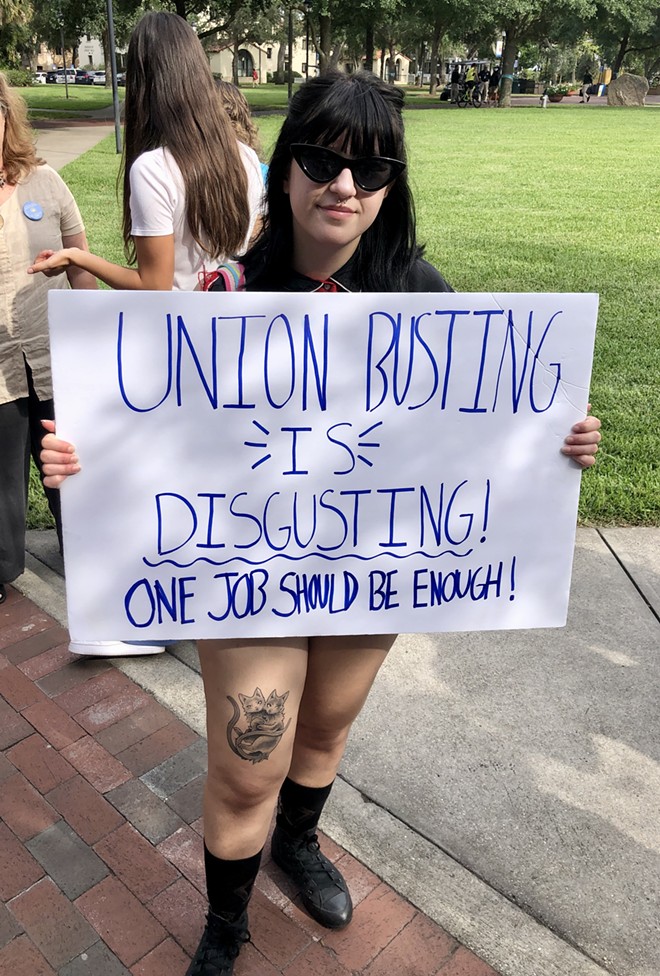 Local college student holds sign reading, "Union busting is disgusting" at a student-organized rally in support of Sodexo workers at Rollins College in Winter Park. - McKenna Schueler