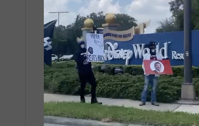 Nazi demonstrators wave DeSantis sign and swastikas outside Disney World in Orlando