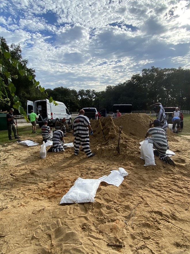 People incarcerated at the Lake County Jail and Detention Center in central Florida fill sandbags at a pickup site organized by the Lake County Sheriff's Office ahead of Hurricane Idalia. (Aug. 29, 2023) - Lake County Sheriff's Office / Facebook