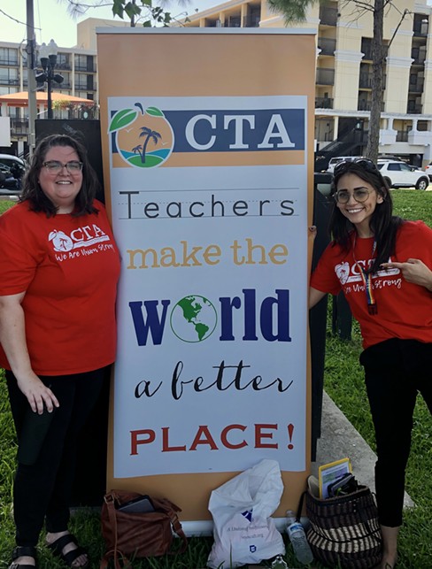 Orange County teachers standing on the outskirts of a rally for LGBTQ and immigrant rights in Orlando, on behalf of their union. - Photo by McKenna Schueler