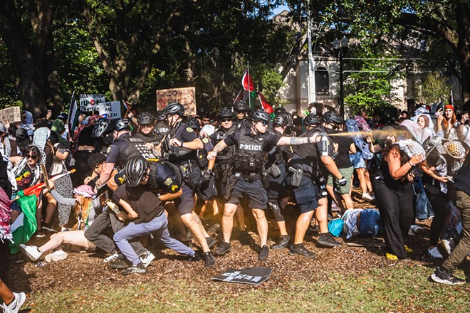 Orlando Police Department officer deploying pepper spray on protesters calling for a permanent ceasefire in Gaza. (May 15, 2024) - Photo by Dave Decker