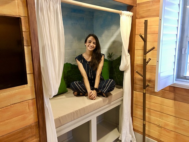 Yasmin Flasterstein, co-founder of Peer Support Space, sits in a reading nook located in a treehouse-themed bedroom for guests of Eva's Casita in Orlando. - Photo by McKenna Schueler