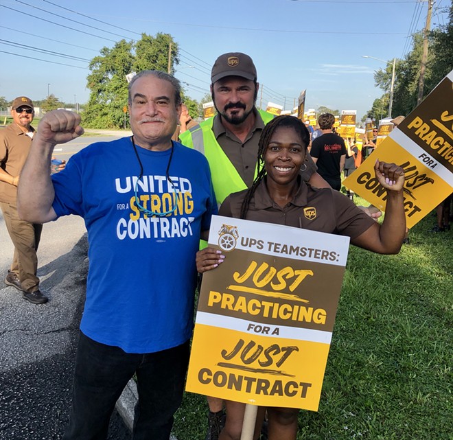 UPS Teamsters (from left to right: Walt Howard, John Gregory, and April Hope) organize a practice picket outside of a UPS warehouse in Orlando. July 13, 2023. - photo by McKenna Schueler