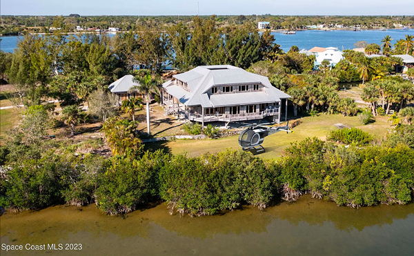 This tropical Florida bungalow home comes with a landing pad for your helicopter