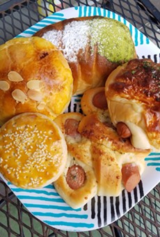 Clockwise from top: Matcha bun, cheese and hot dog bun, garlic and hot dog bun, Sweetheart cookie, pineapple taro bun