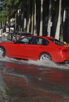 A car drives through flooded streets in Miami