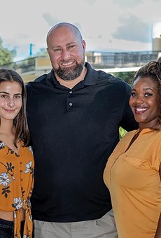 Jeremy Sisson (center) with his daughter and his wife, Briana