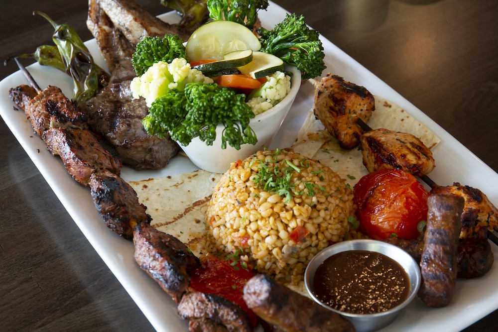 The Bridge Special Selection: Two gorgeous lamb chops, mini beef sausages, and brochettes of seasoned filet mignon and chicken served over lavash, with bulgur and seasonal vegetables