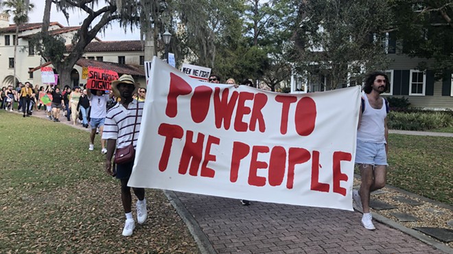 Students and faculty at Rollins College march in support of dining workers' rights to organize for a union.