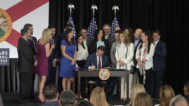 Florida Gov. Ron DeSantis signs into law multiple education bills, including a bill targeting teachers unions, on May 9, 2023.