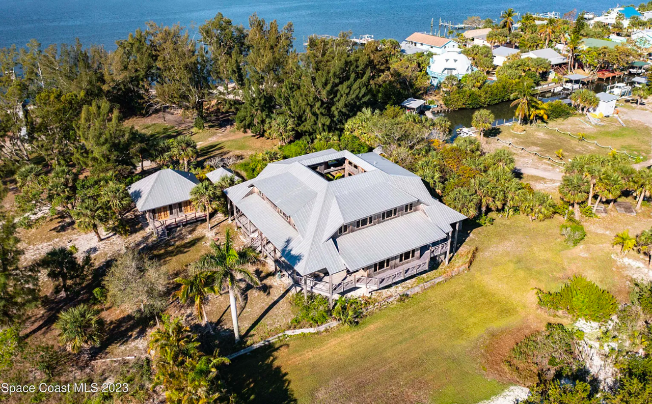 This tropical Florida bungalow home comes with a landing pad for your helicopter