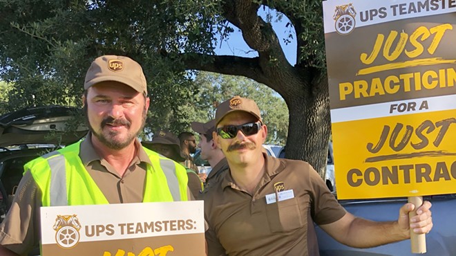 John Gregory, a UPS driver of over 30 years, stands with a fellow UPS Teamster as they practice for a picket line ahead of a potential nationwide strike. July 13, 2023.