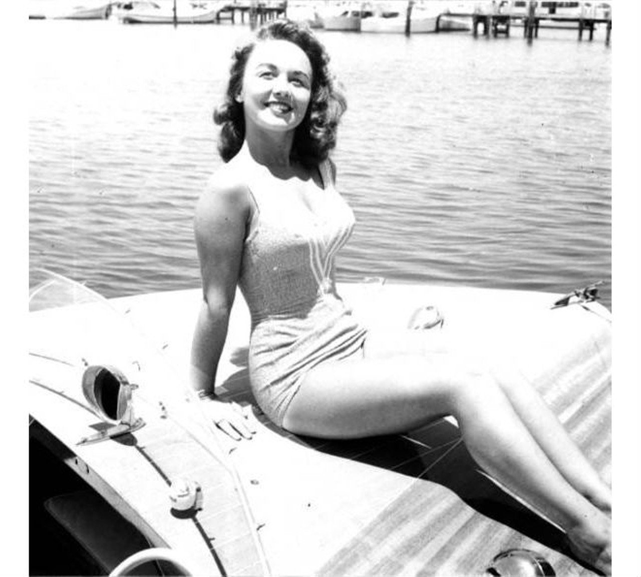 Young woman posing on a small motorboat