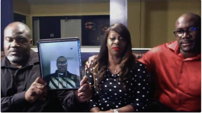 Floyd family with a picture of George Floyd who was a victim of police brutality