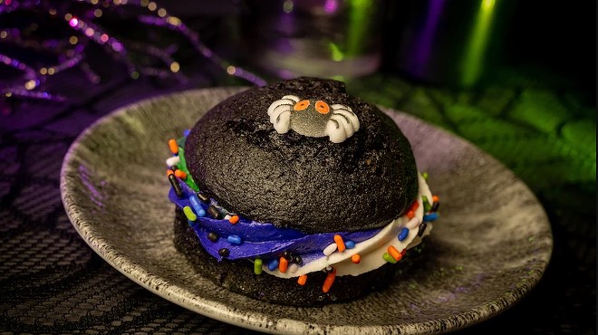 Liberty Square Market: black velvet cookie with buttercream and sprinkles topped with a sugar spider